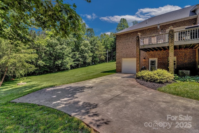 2790 Twin Oaks Dr, Morganton, NC 28655 - view of side of property with brick siding, a yard, an attached garage, driveway, and a wooden deck