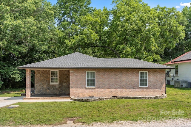 1116 S Juniper St, Kannapolis, NC 28081 - view of front of home featuring a front lawn, a shingled roof, a porch, brick siding, and central air condition unit