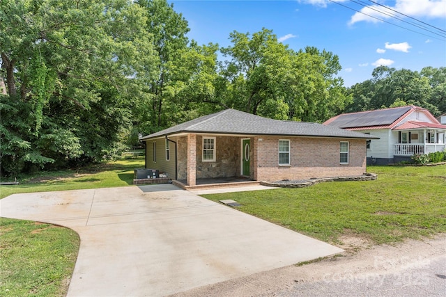 1116 S Juniper St, Kannapolis, NC 28081 - view of front facade with a porch, a front lawn, brick siding, and driveway