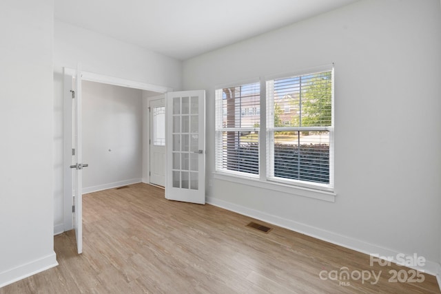 207 Welcombe St, Mooresville, NC 28115 - spare room with french doors, light wood finished floors, and baseboards