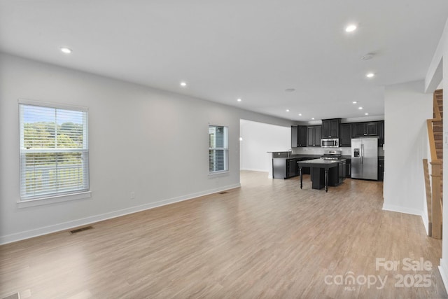 207 Welcombe St, Mooresville, NC 28115 - living area with recessed lighting, light wood-type flooring, and baseboards