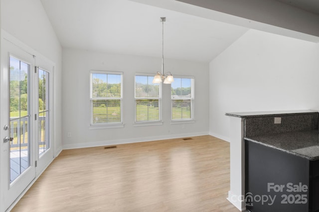 207 Welcombe St, Mooresville, NC 28115 - unfurnished dining area with lofted ceiling, light wood-type flooring, a chandelier, healthy amount of natural light, and baseboards