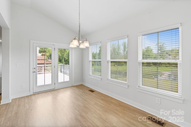 207 Welcombe St, Mooresville, NC 28115 - unfurnished dining area with a chandelier, wood finished floors, vaulted ceiling, and baseboards