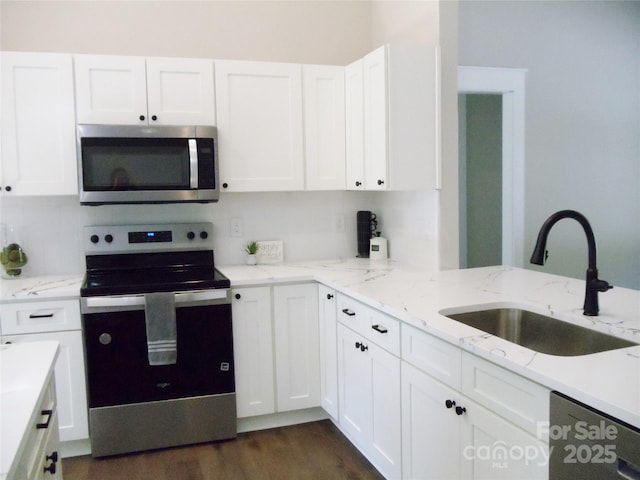 1802 Cooper Ave, Kannapolis, NC 28081 - kitchen featuring stainless steel appliances, a sink, white cabinets, light stone counters, and dark wood finished floors