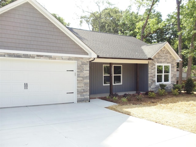 1802 Cooper Ave, Kannapolis, NC 28081 - view of front facade with stone siding, an attached garage, a shingled roof, covered porch, and concrete driveway