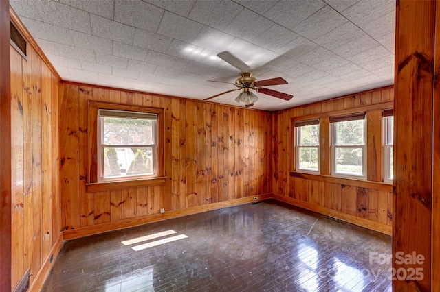 3960 Old Clyde Rd, Clyde, NC 28721 - empty room featuring baseboards, healthy amount of natural light, wood walls, and a ceiling fan