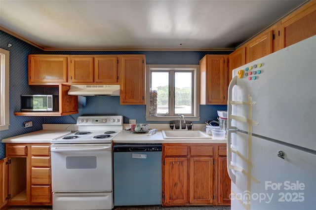 3960 Old Clyde Rd, Clyde, NC 28721 - kitchen with white appliances, under cabinet range hood, a sink, light countertops, and wallpapered walls