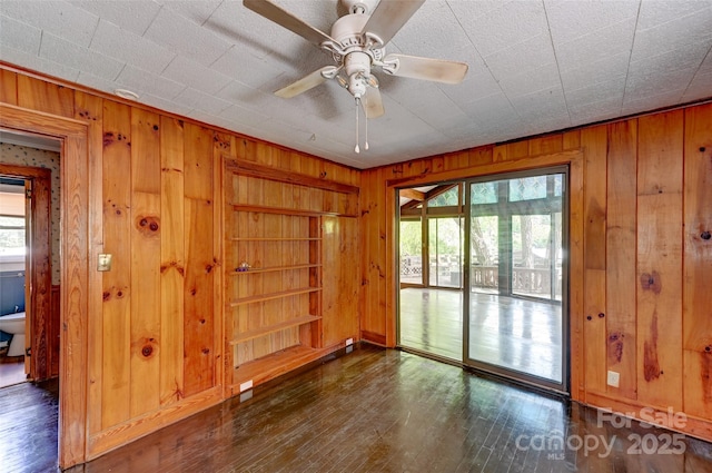 3960 Old Clyde Rd, Clyde, NC 28721 - unfurnished room featuring wooden walls, hardwood / wood-style floors, and ceiling fan