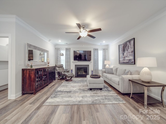 647 R L Stowe Rd, Belmont, NC 28012 - living room with ceiling fan, baseboards, a glass covered fireplace, ornamental molding, and wood finished floors