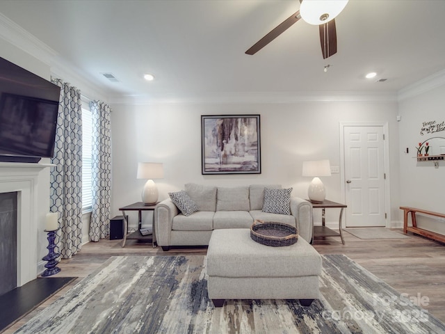 647 R L Stowe Rd, Belmont, NC 28012 - living room featuring wood finished floors, a ceiling fan, baseboards, crown molding, and a fireplace