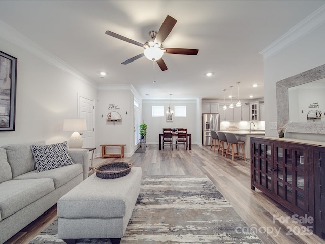 647 R L Stowe Rd, Belmont, NC 28012 - living room featuring light wood-type flooring, ornamental molding, a ceiling fan, recessed lighting, and baseboards