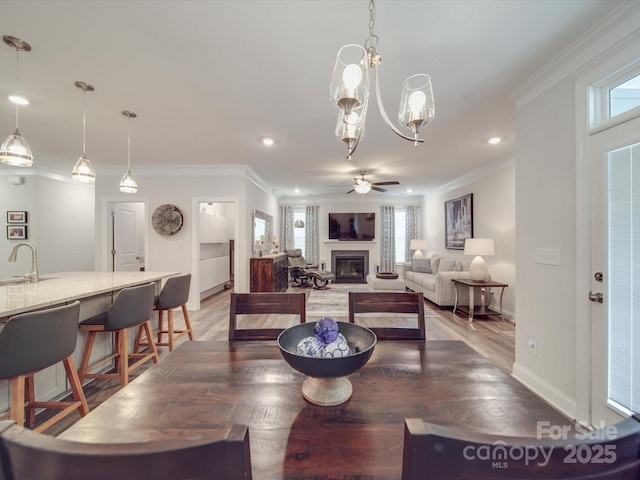647 R L Stowe Rd, Belmont, NC 28012 - dining space with ornamental molding, plenty of natural light, a ceiling fan, baseboards, and light wood-style flooring