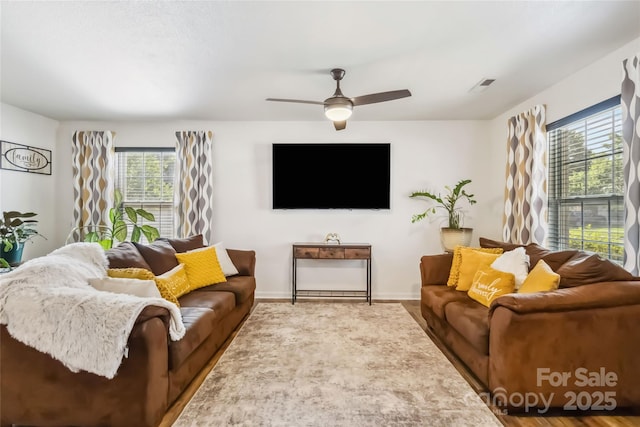 925 Skywatch Ln, Monroe, NC 28112 - living area featuring healthy amount of natural light, ceiling fan, wood finished floors, and baseboards