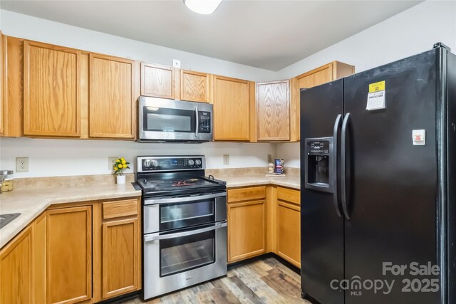 925 Skywatch Ln, Monroe, NC 28112 - kitchen with stainless steel appliances, light countertops, and light wood-style flooring