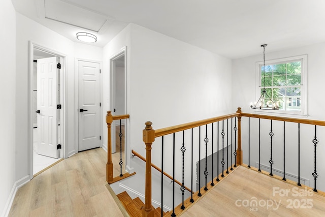 9513 Saddle Run Trl, Charlotte, NC 28269 - hallway with an upstairs landing, wood finished floors, and baseboards