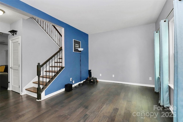 7434 Dover Mill Ln SW, Concord, NC 28025 - unfurnished living room featuring wood finished floors, stairs, and baseboards