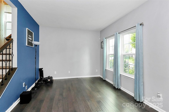 7434 Dover Mill Ln SW, Concord, NC 28025 - empty room with dark wood-style floors, stairs, and baseboards