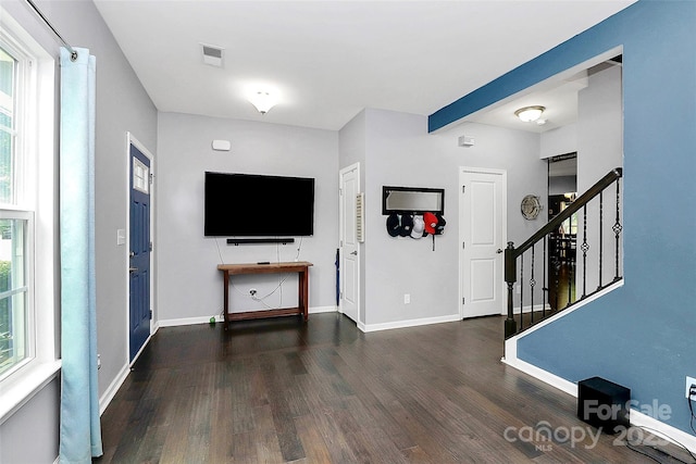 7434 Dover Mill Ln SW, Concord, NC 28025 - unfurnished living room featuring wood finished floors, stairway, and baseboards