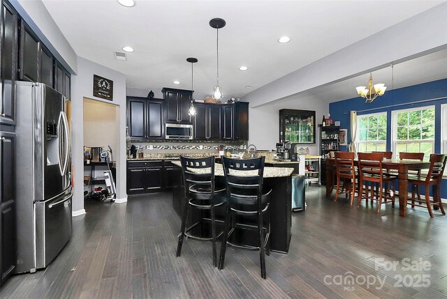 7434 Dover Mill Ln SW, Concord, NC 28025 - kitchen with stainless steel appliances, a chandelier, dark wood finished floors, a kitchen island, and recessed lighting