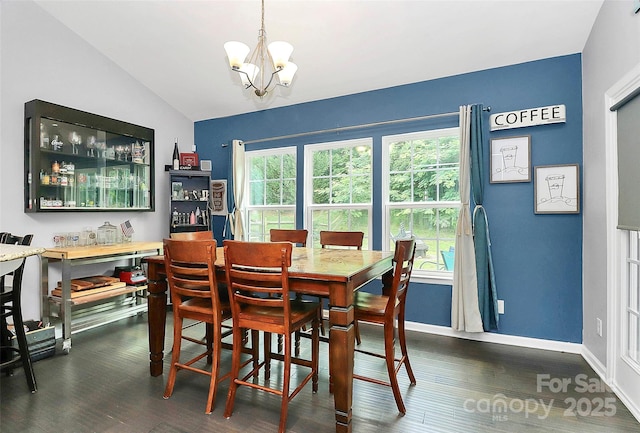 7434 Dover Mill Ln SW, Concord, NC 28025 - dining area featuring lofted ceiling, a chandelier, dark wood-style flooring, and baseboards