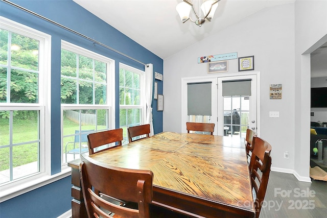 7434 Dover Mill Ln SW, Concord, NC 28025 - dining area featuring a chandelier, vaulted ceiling, baseboards, healthy amount of natural light, and dark wood-style floors