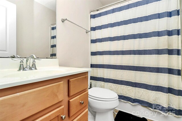 7434 Dover Mill Ln SW, Concord, NC 28025 - bathroom featuring vanity, toilet, and a shower with shower curtain