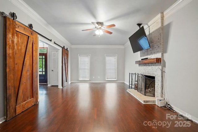 8708 Piccone Brook Ln, Charlotte, NC 28216 - unfurnished living room featuring a barn door, wood finished floors, ceiling fan, and ornamental molding