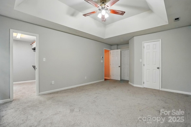 8708 Piccone Brook Ln, Charlotte, NC 28216 - unfurnished bedroom with a tray ceiling, carpet, a walk in closet, and baseboards