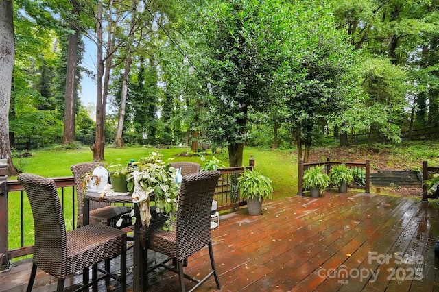 8708 Piccone Brook Ln, Charlotte, NC 28216 - wooden terrace with a lawn, view of wooded area, and outdoor dining space