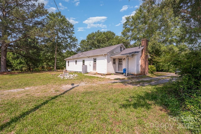 3595 Mt Holly Rd, Edgemoor, SC 29712 - rear view of house with a chimney and a yard