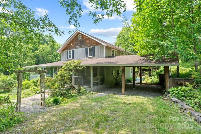 20 Pickens Ln, Weaverville, NC 28787 - rear view of house featuring a sunroom, an attached carport, and a shingled roof