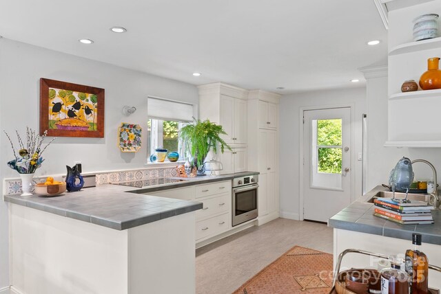 20 Pickens Ln, Weaverville, NC 28787 - kitchen featuring stainless steel oven, tile countertops, open shelves, healthy amount of natural light, and recessed lighting
