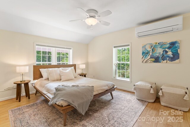 20 Pickens Ln, Weaverville, NC 28787 - bedroom featuring a wall mounted AC, multiple windows, light wood finished floors, baseboards, and vaulted ceiling