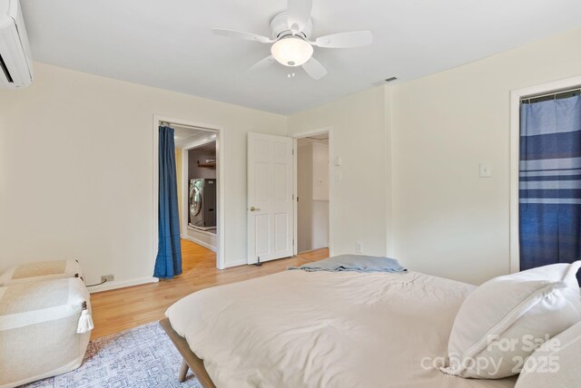 20 Pickens Ln, Weaverville, NC 28787 - bedroom featuring a wall mounted air conditioner, light wood-style floors, baseboards, and a ceiling fan