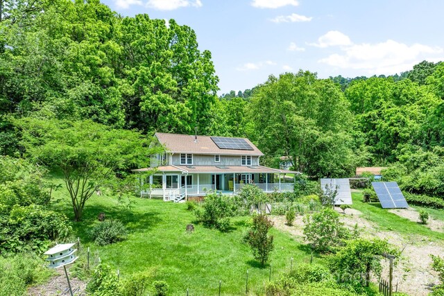 20 Pickens Ln, Weaverville, NC 28787 - rear view of house featuring ground mounted solar panels, a wooded view, and roof with shingles