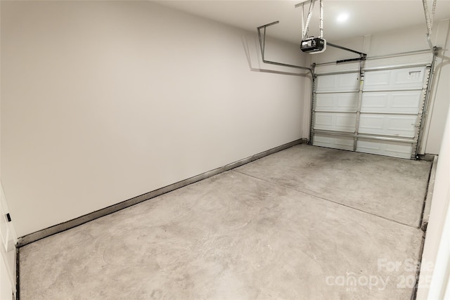 619 Billingsley Rd, Charlotte, NC 28211 - garage featuring a garage door opener and baseboards