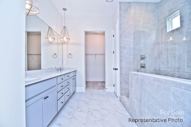 4178 Millstream Rd, Denver, NC 28037 - bathroom with double vanity, marble look tiles, a spacious closet, and walk in shower