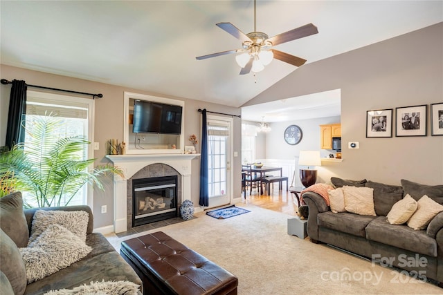 1209 Danielle Downs Ct SE, Concord, NC 28025 - carpeted living area featuring lofted ceiling, ceiling fan, healthy amount of natural light, a chandelier, and a tiled fireplace