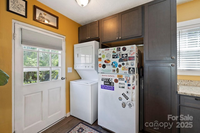 32 Roberts St, Fletcher, NC 28732 - laundry room with estacked washer and dryer and dark wood-type flooring