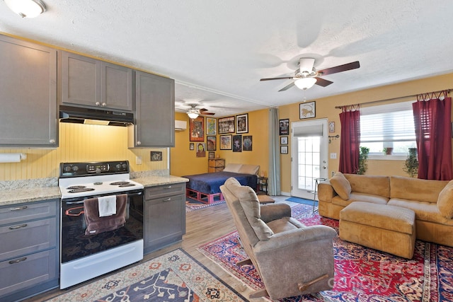 32 Roberts St, Fletcher, NC 28732 - kitchen with white electric range, under cabinet range hood, a ceiling fan, open floor plan, and gray cabinets