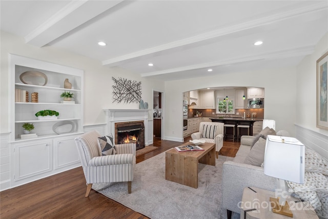 7213 Lancer Dr, Charlotte, NC 28226 - living area with dark wood-type flooring, beam ceiling, arched walkways, a fireplace, and recessed lighting