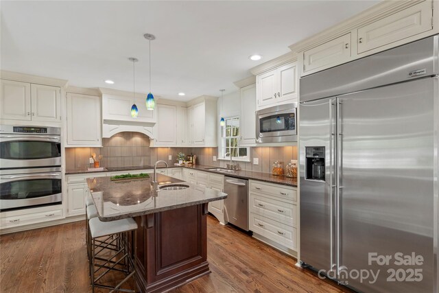 7213 Lancer Dr, Charlotte, NC 28226 - kitchen featuring built in appliances, a sink, dark stone countertops, recessed lighting, and backsplash