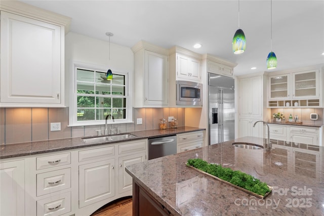 7213 Lancer Dr, Charlotte, NC 28226 - kitchen featuring a sink, built in appliances, tasteful backsplash, dark stone counters, and recessed lighting