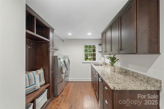 7213 Lancer Dr, Charlotte, NC 28226 - laundry room featuring separate washer and dryer, cabinet space, baseboards, wood finished floors, and recessed lighting