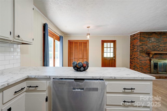 3043 Charles Rd, Shelby, NC 28152 - kitchen with dishwasher, a textured ceiling, light wood-style flooring, white cabinetry, and light stone countertops