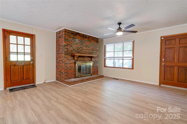 3043 Charles Rd, Shelby, NC 28152 - unfurnished living room with a textured ceiling, wood finished floors, crown molding, a ceiling fan, and a fireplace