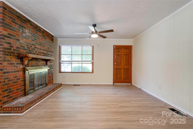3043 Charles Rd, Shelby, NC 28152 - unfurnished living room featuring light wood finished floors, a fireplace, ceiling fan, ornamental molding, and baseboards