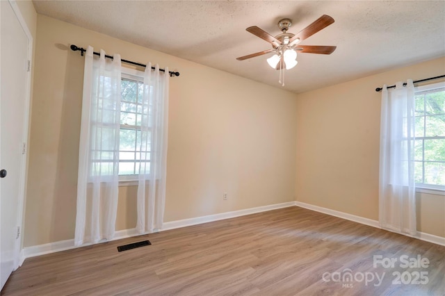 3043 Charles Rd, Shelby, NC 28152 - unfurnished room with wood finished floors, ceiling fan, a textured ceiling, and baseboards