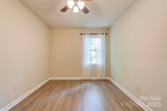 3043 Charles Rd, Shelby, NC 28152 - spare room featuring wood finished floors, ceiling fan, and baseboards