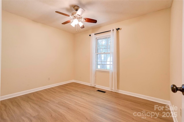 3043 Charles Rd, Shelby, NC 28152 - unfurnished room featuring light wood-style floors, a ceiling fan, and baseboards
